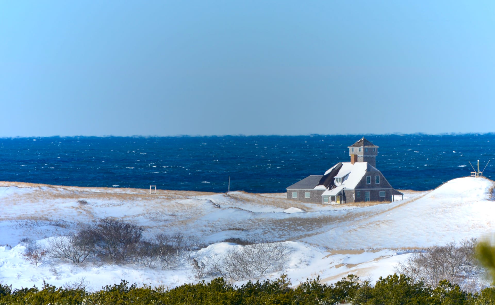 Brant Point lighthouse with harbor views and luxury waterfront estates